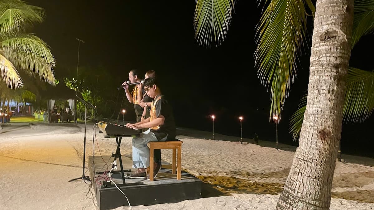 Live acoustic band playing at beachfront bar